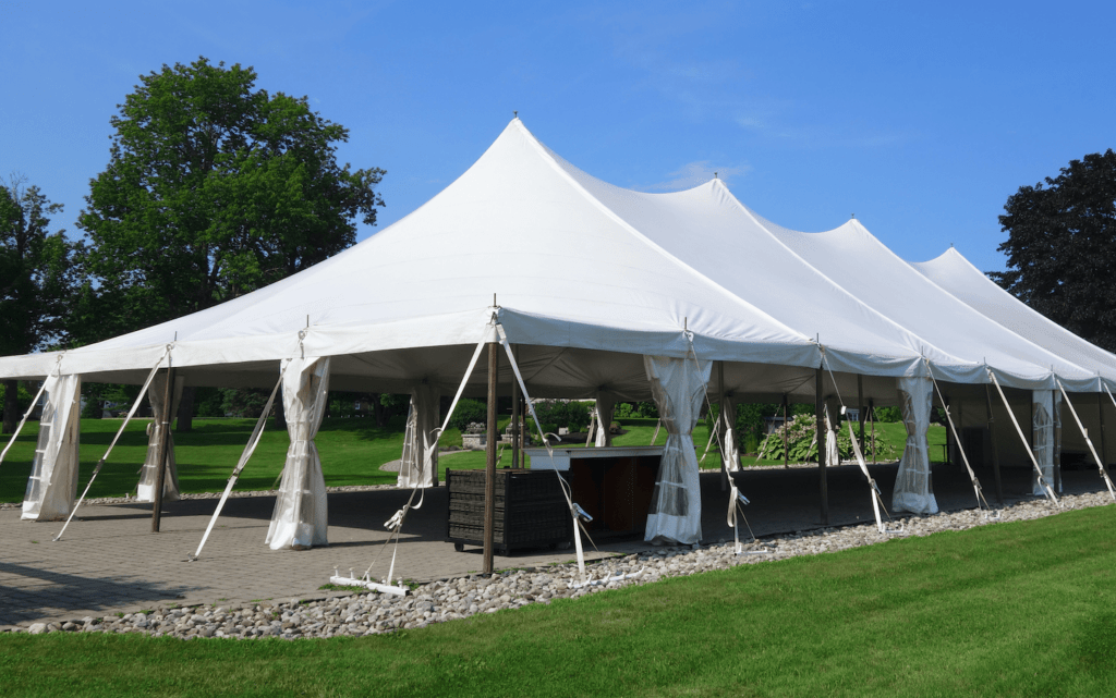 Large white outdoor event tent installed on grass in Ogden, UT