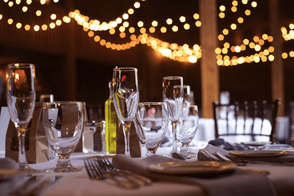 Elegant table and chair rental setup with lighting for evening events