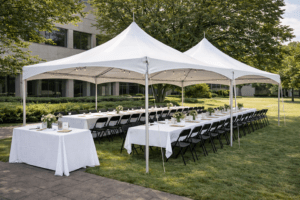 Wedding tables and chairs setup under event tent